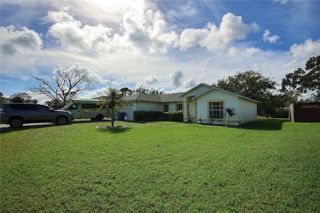 single story home featuring a front lawn