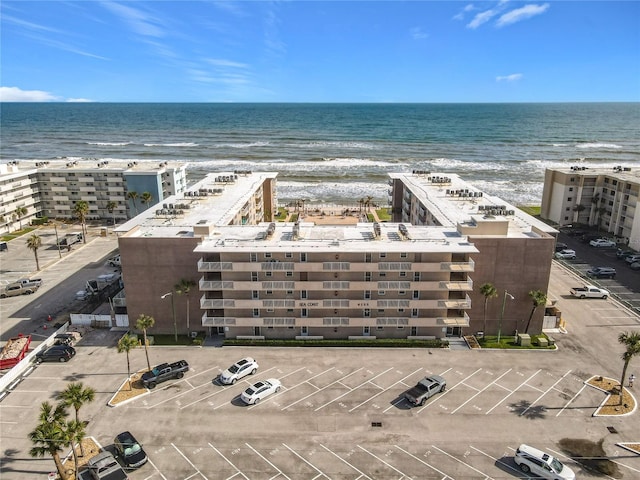 drone / aerial view featuring a view of the beach and a water view