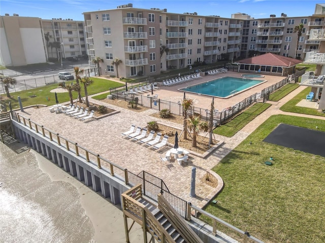 view of pool with a patio area and a yard