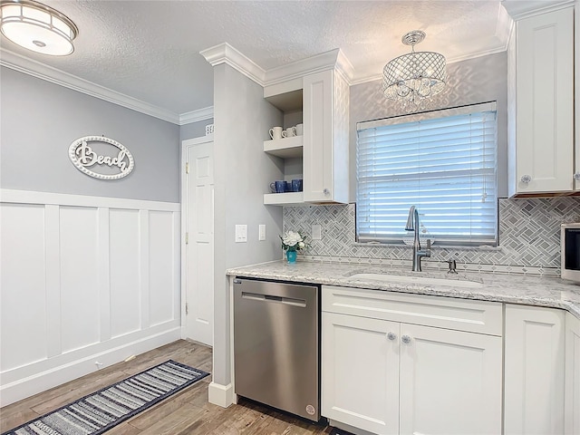 kitchen featuring light stone countertops, white cabinetry, sink, and stainless steel dishwasher