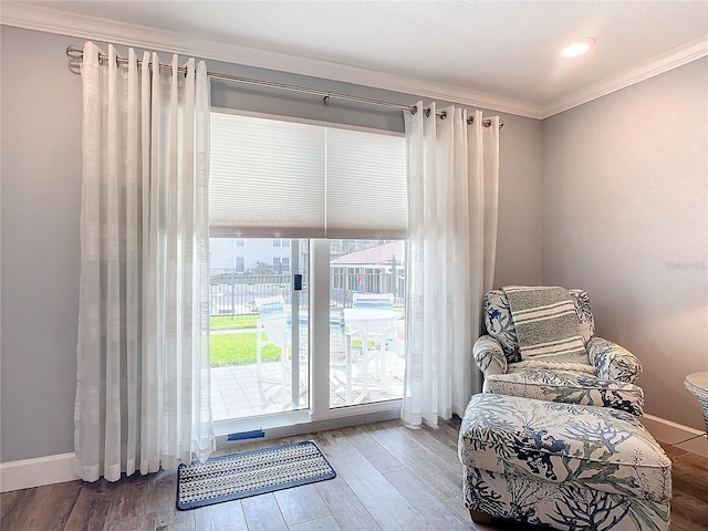 sitting room featuring hardwood / wood-style flooring and crown molding