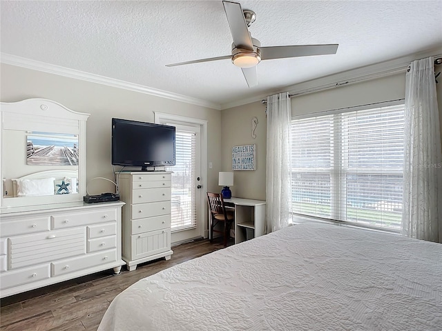 bedroom with dark wood-type flooring, access to outside, ceiling fan, ornamental molding, and a textured ceiling