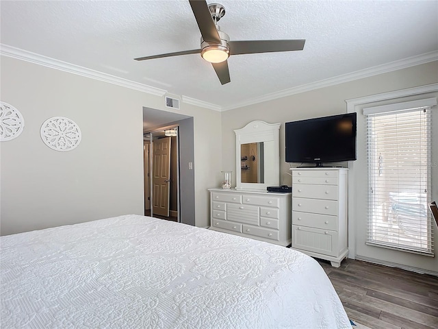 bedroom featuring hardwood / wood-style floors, ceiling fan, crown molding, and multiple windows