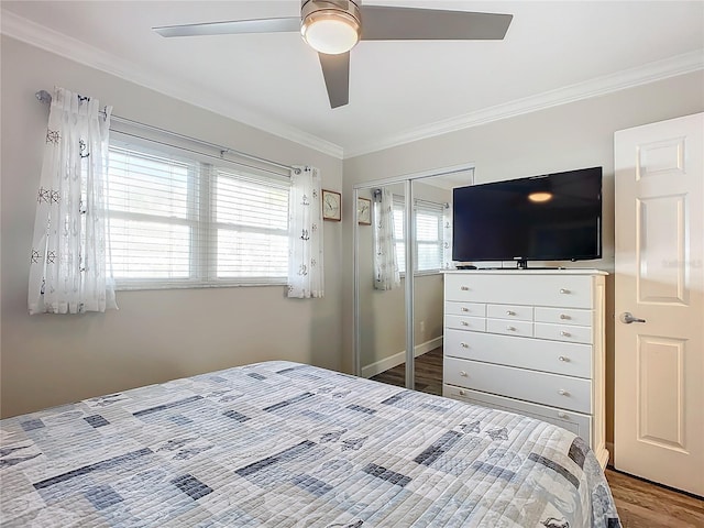 bedroom featuring wood-type flooring, a closet, crown molding, and ceiling fan