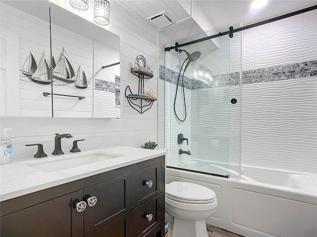 full bathroom featuring shower / bath combination with glass door, wooden walls, vanity, and toilet