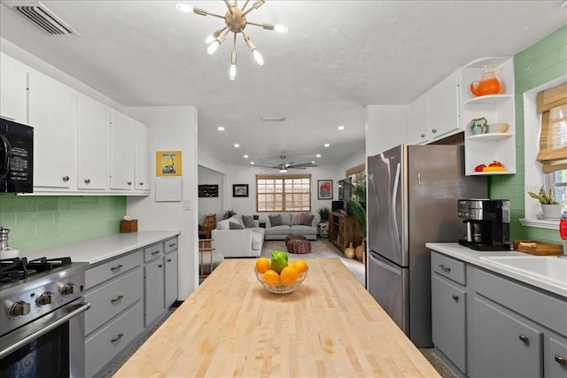 kitchen featuring gray cabinetry, white cabinetry, and appliances with stainless steel finishes