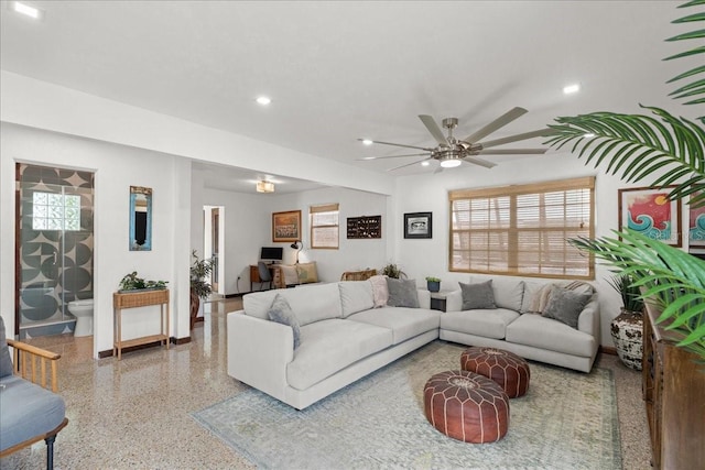 living room with ceiling fan and a healthy amount of sunlight