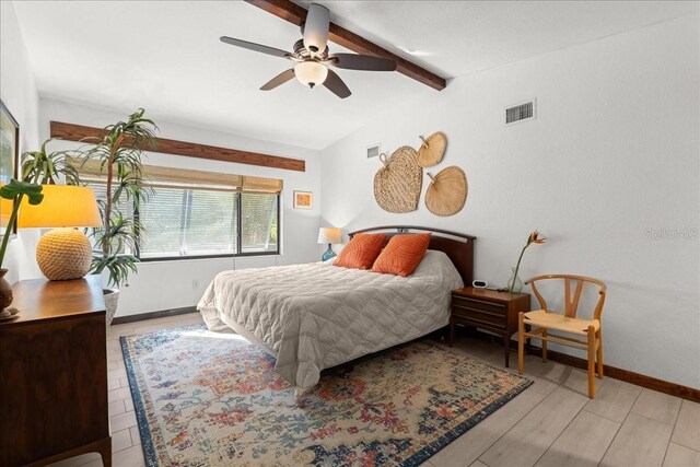 bedroom featuring ceiling fan and lofted ceiling with beams