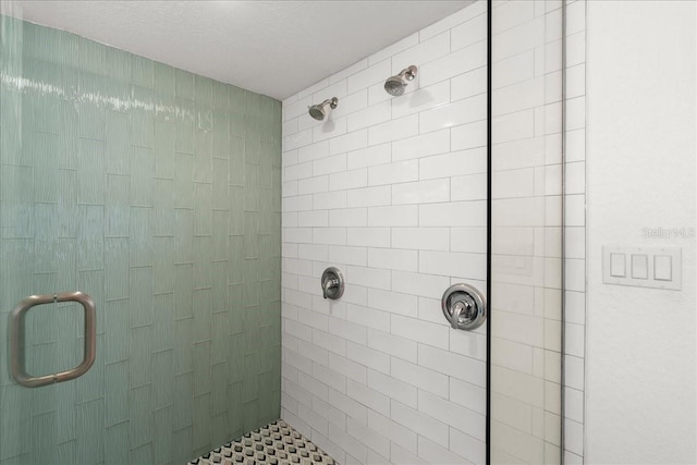 bathroom featuring a textured ceiling and an enclosed shower