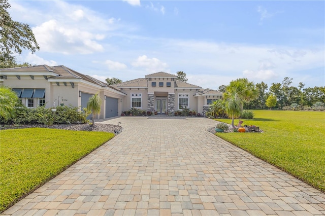 mediterranean / spanish house featuring a garage and a front yard