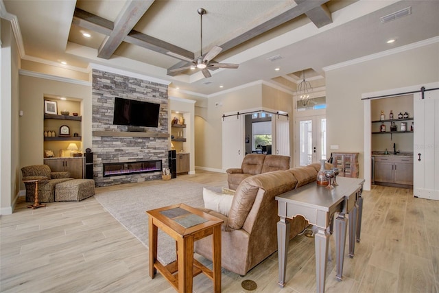 living room with light wood-type flooring, a barn door, coffered ceiling, beamed ceiling, and ceiling fan