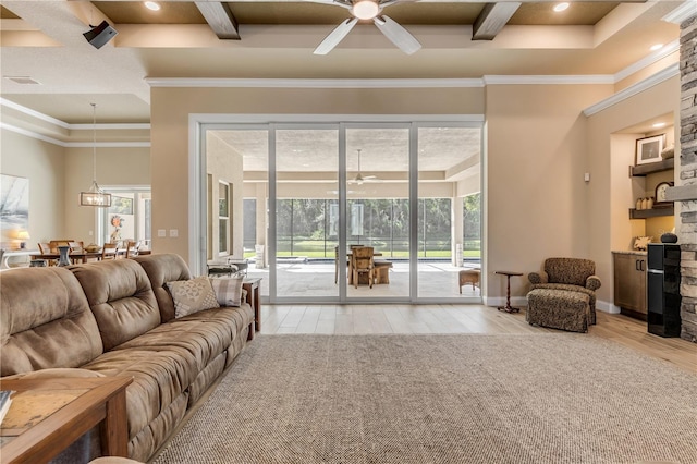 living room featuring a wealth of natural light, light wood-type flooring, and ornamental molding