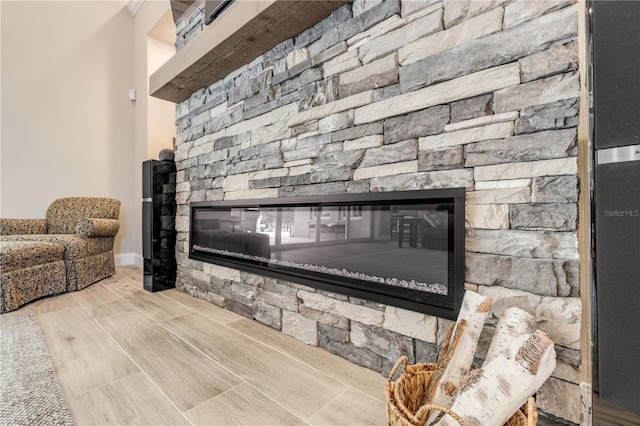 room details featuring hardwood / wood-style flooring and a stone fireplace