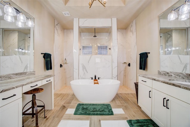 bathroom with vanity, separate shower and tub, and tile walls