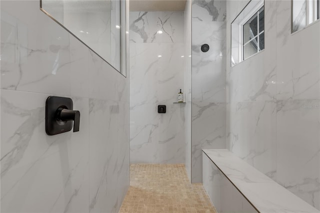 bathroom featuring a tile shower