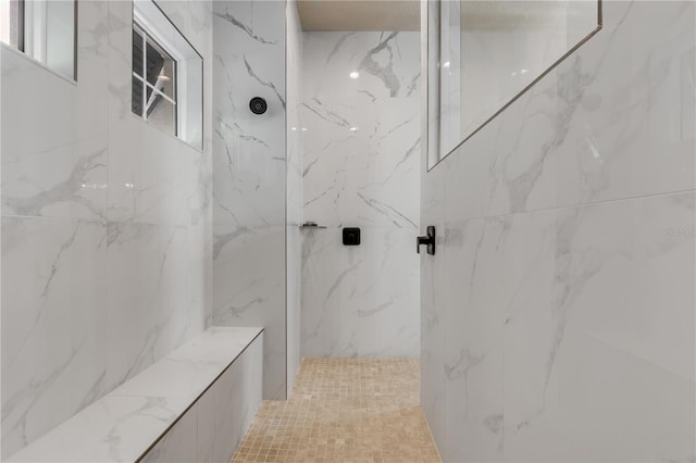 bathroom featuring a tile shower