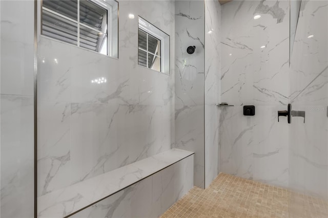 bathroom featuring a tile shower