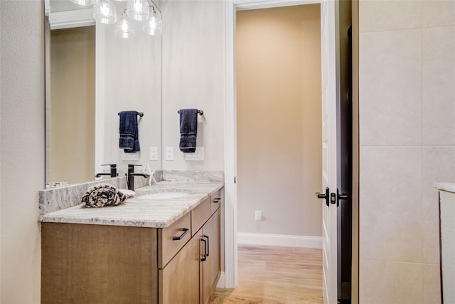 bathroom with vanity and hardwood / wood-style flooring