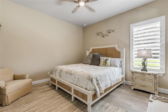 bedroom with light hardwood / wood-style flooring and ceiling fan