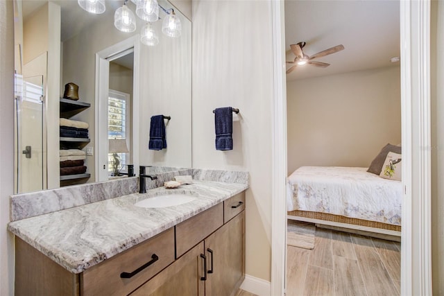 bathroom featuring vanity, ceiling fan, and wood-type flooring