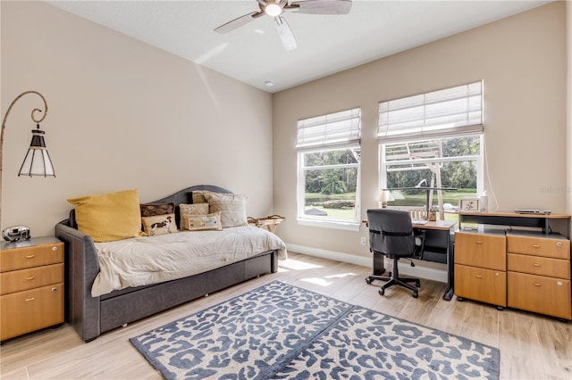 bedroom with ceiling fan and light hardwood / wood-style flooring