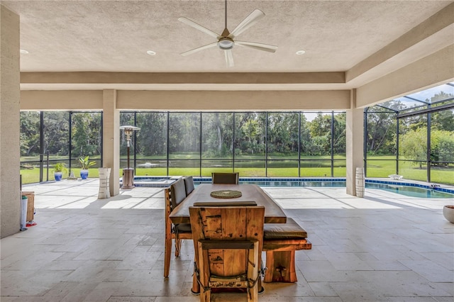 view of patio featuring glass enclosure, an outdoor bar, and ceiling fan