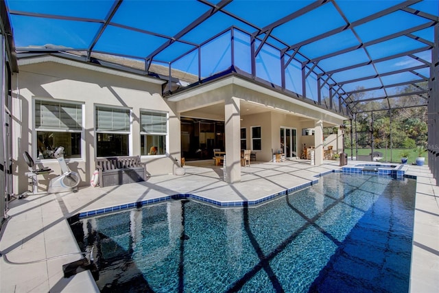 view of pool featuring a patio area, a lanai, and an in ground hot tub