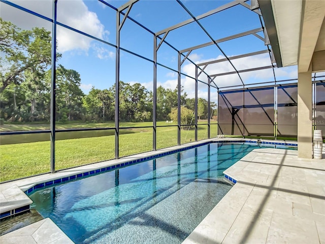 view of swimming pool with a patio, a lawn, and a lanai