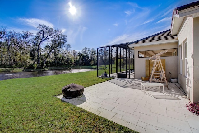 view of patio with glass enclosure, a water view, and a fire pit