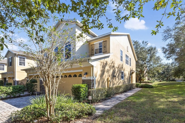 view of front of home with a garage and a front lawn