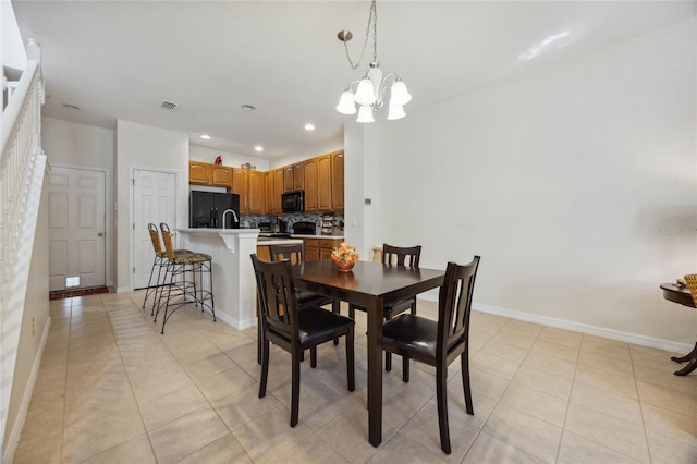 tiled dining area with a chandelier