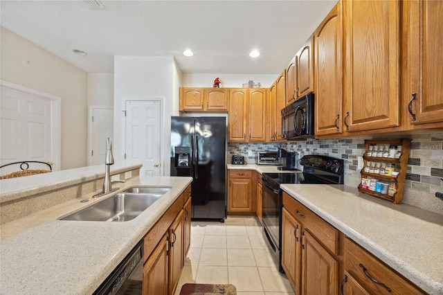 kitchen with light tile patterned floors, sink, tasteful backsplash, and black appliances