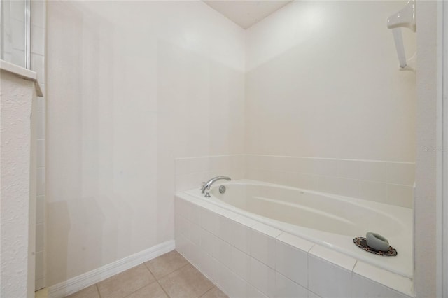 bathroom featuring tile patterned flooring and tiled bath