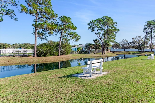 exterior space featuring a water view and a yard