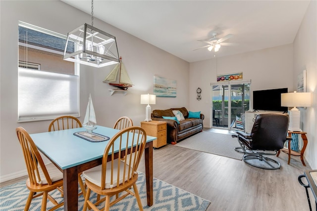 dining area with wood-type flooring and ceiling fan