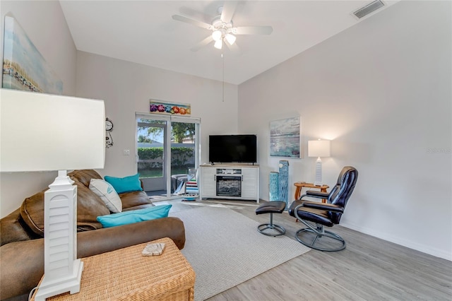 living room featuring hardwood / wood-style floors and ceiling fan