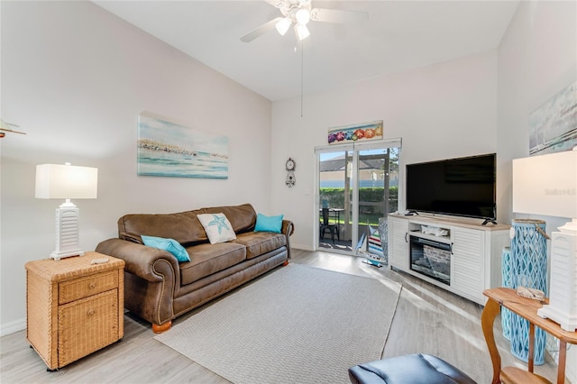 living room featuring ceiling fan and light wood-type flooring