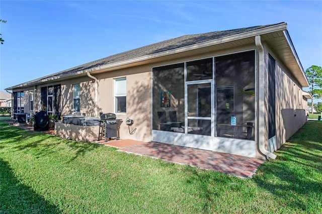 back of house featuring a sunroom and a yard