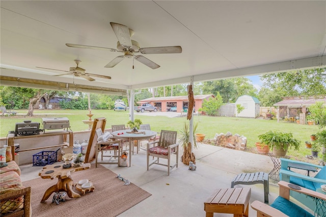 view of patio / terrace with ceiling fan and a shed