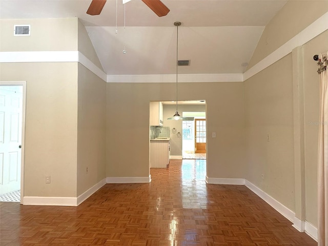 unfurnished dining area with lofted ceiling, sink, dark parquet flooring, and ceiling fan