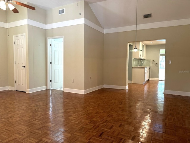 unfurnished room with ceiling fan, dark parquet flooring, sink, and high vaulted ceiling