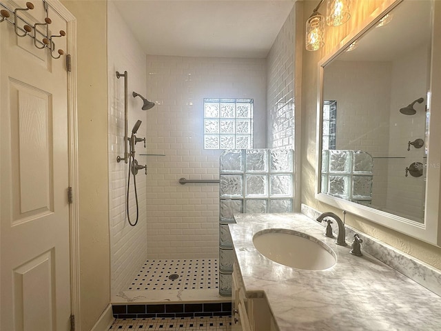 bathroom with vanity and tiled shower