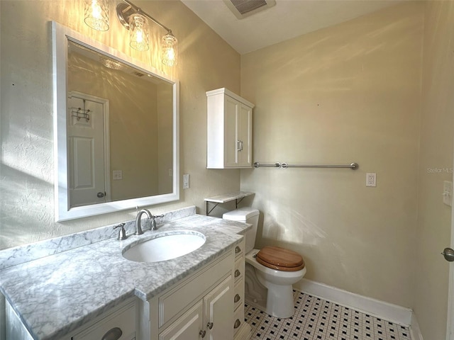 bathroom with vanity and toilet