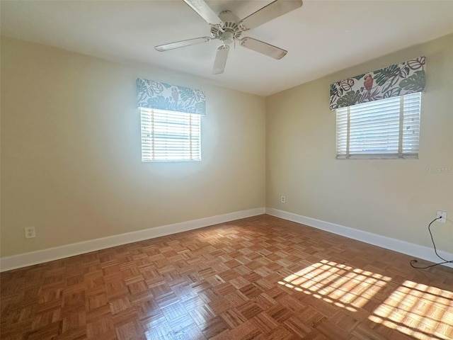 unfurnished room featuring ceiling fan and light parquet flooring