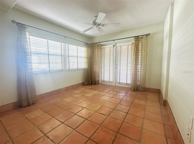 empty room featuring light tile patterned flooring and ceiling fan