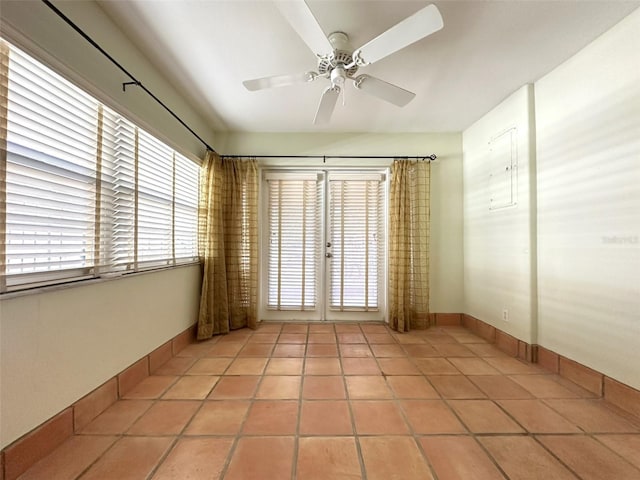 tiled empty room with ceiling fan