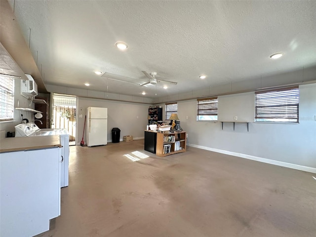 basement featuring ceiling fan, washer and clothes dryer, a textured ceiling, and white fridge