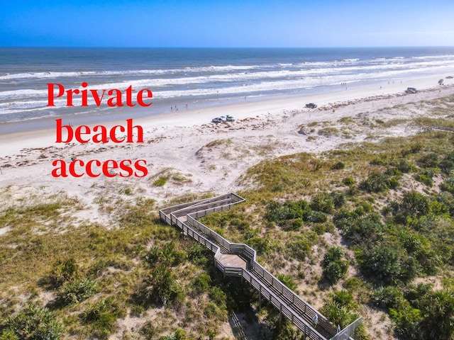 drone / aerial view with a view of the beach and a water view