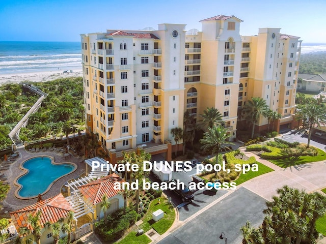 view of building exterior featuring a view of the beach and a water view