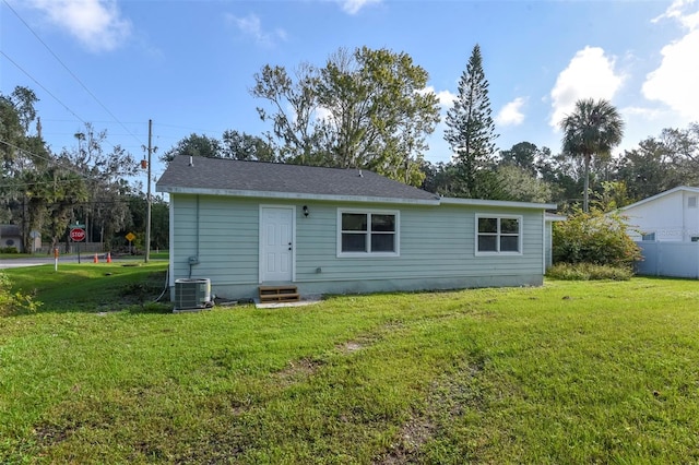 back of house featuring a yard and central air condition unit